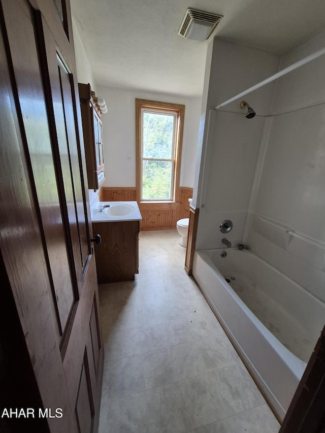 1302 3rd Ave, Altoona, PA 16602 - full bath featuring wainscoting, vanity, washtub / shower combination, wooden walls, and tile patterned floors