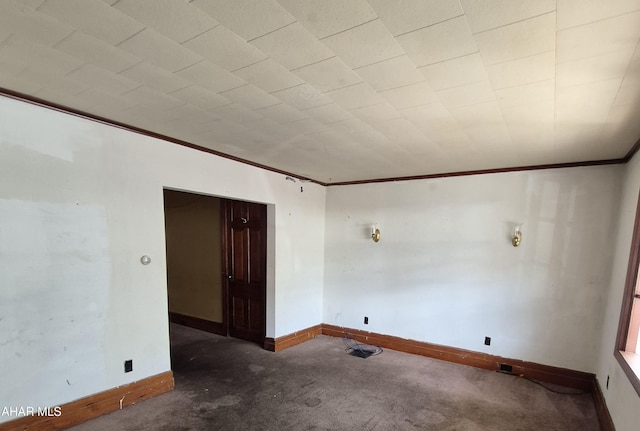 unfurnished room with crown molding and dark carpet