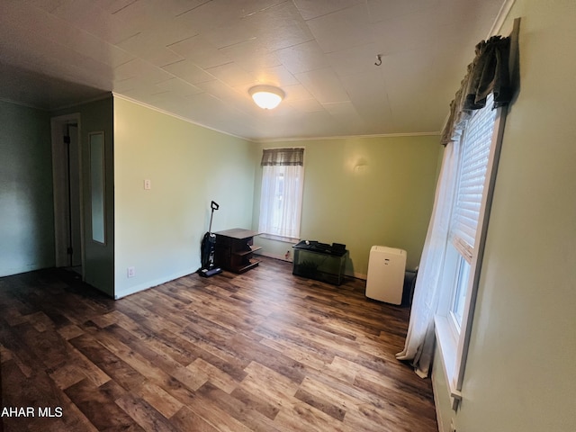 spare room with plenty of natural light, ornamental molding, and hardwood / wood-style flooring