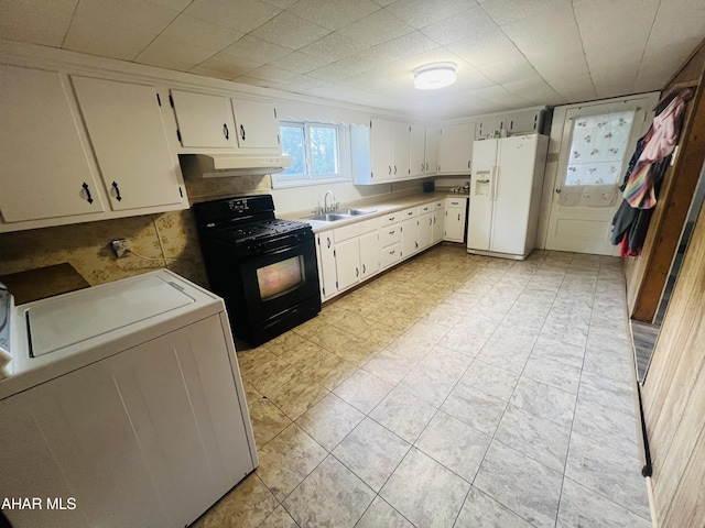 kitchen featuring white fridge with ice dispenser, white cabinets, black gas range oven, and washer / dryer