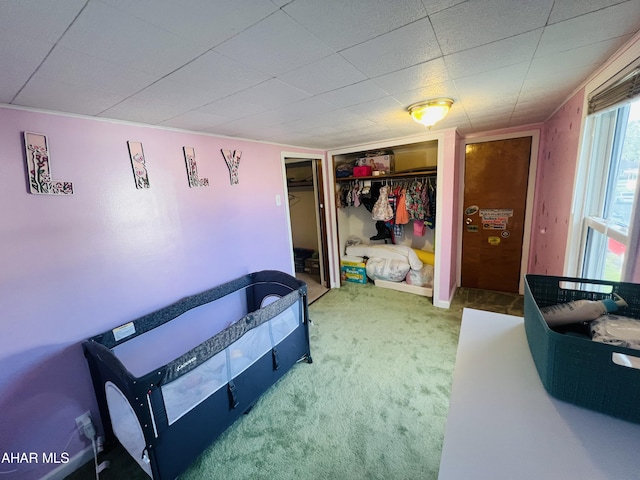 bedroom with carpet and a closet