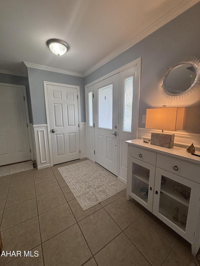 215 Red Fox Dr, Duncansville, PA 16635 - entrance foyer featuring crown molding, dark tile patterned flooring, and a wainscoted wall
