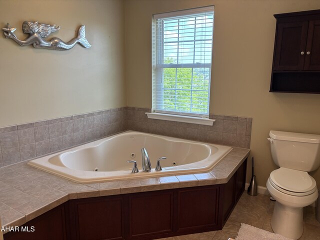 215 Red Fox Dr, Duncansville, PA 16635 - full bathroom with toilet, a jetted tub, healthy amount of natural light, and tile patterned floors