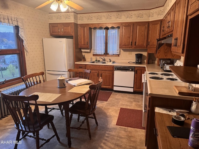 kitchen featuring white appliances, ceiling fan, and sink