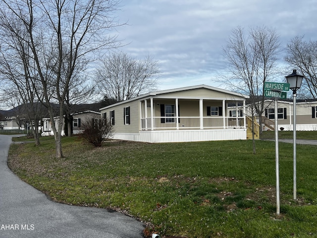 view of front of house featuring covered porch and a front yard