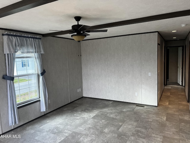 unfurnished room featuring beam ceiling and ceiling fan