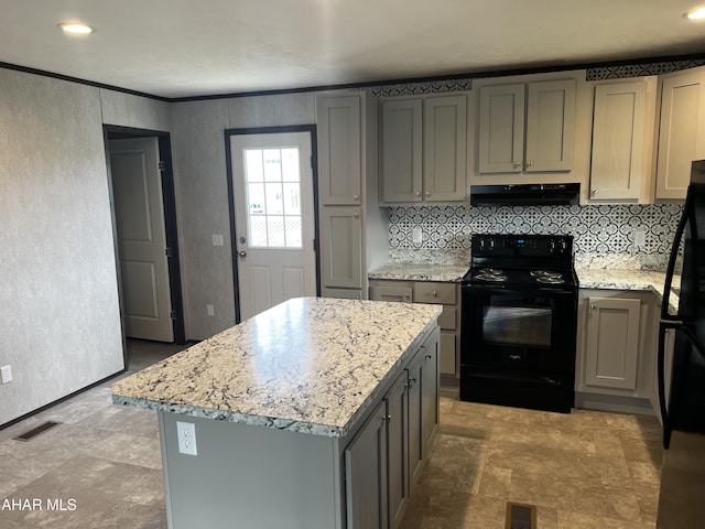 kitchen with gray cabinetry, light stone counters, a kitchen island, and black appliances