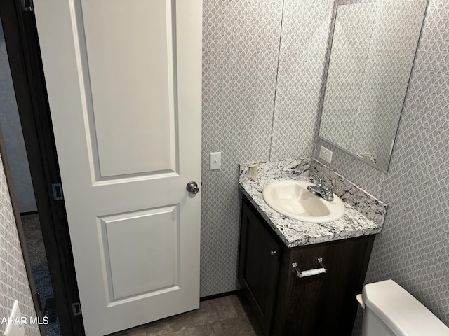 bathroom with tile patterned flooring, vanity, tile walls, and toilet