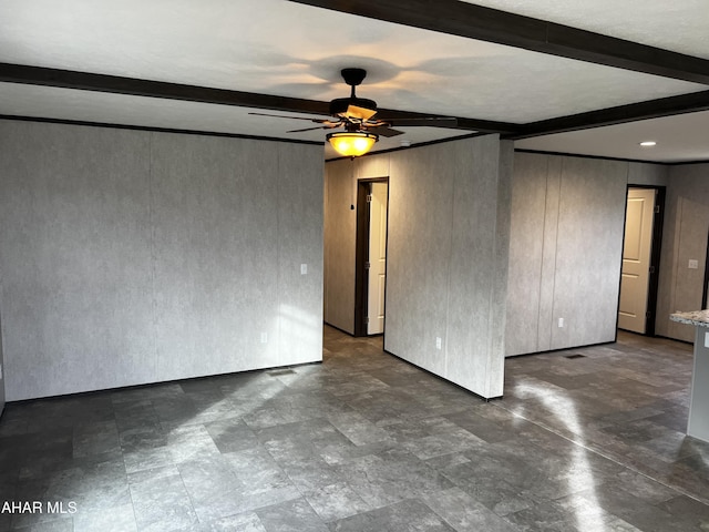 spare room featuring beamed ceiling