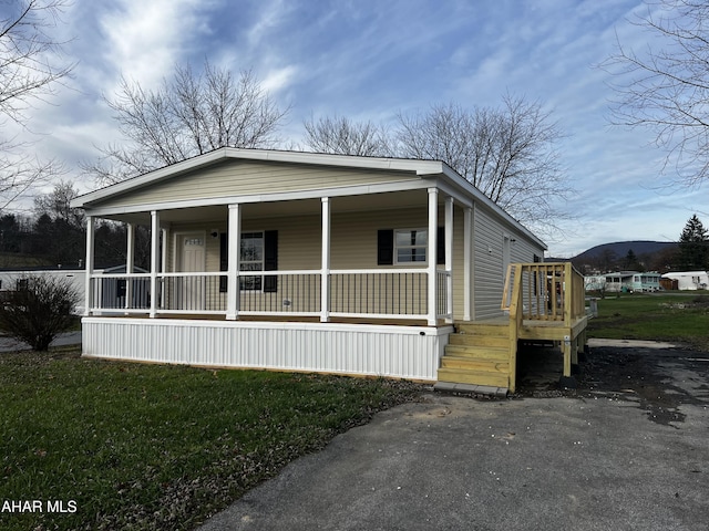 view of front of property with covered porch and a front yard