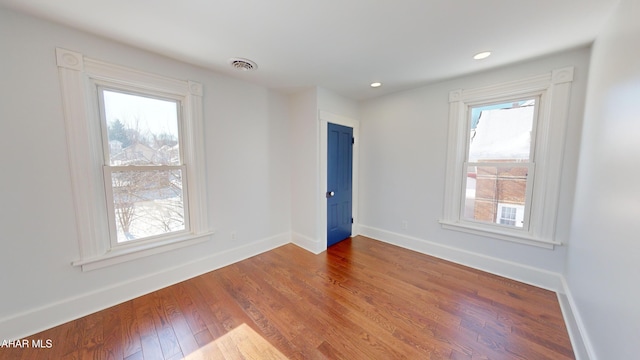 spare room with wood-type flooring