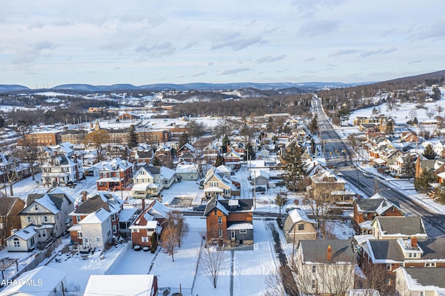 snowy aerial view with a mountain view