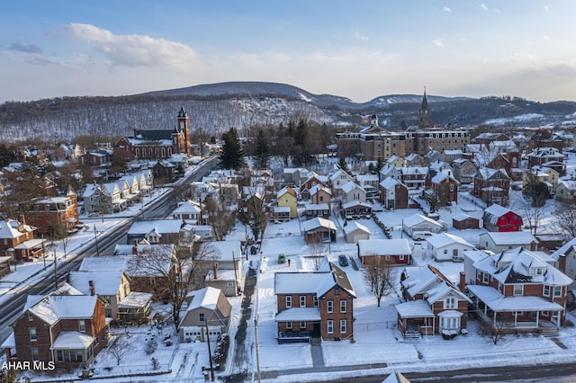 snowy aerial view featuring a mountain view