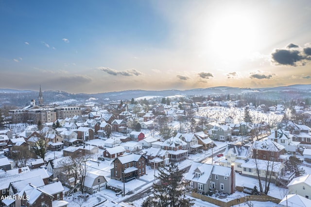 snowy aerial view featuring a mountain view