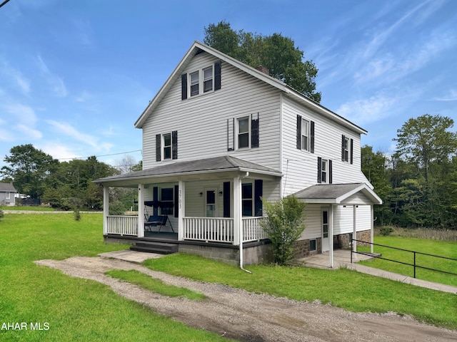 farmhouse with covered porch and a front yard