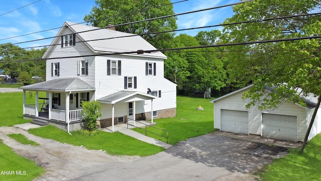 view of front of house with a porch, a garage, an outbuilding, and a front yard