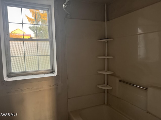 bathroom featuring bathing tub / shower combination and a wealth of natural light