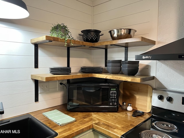 details with backsplash, sink, wooden counters, and range