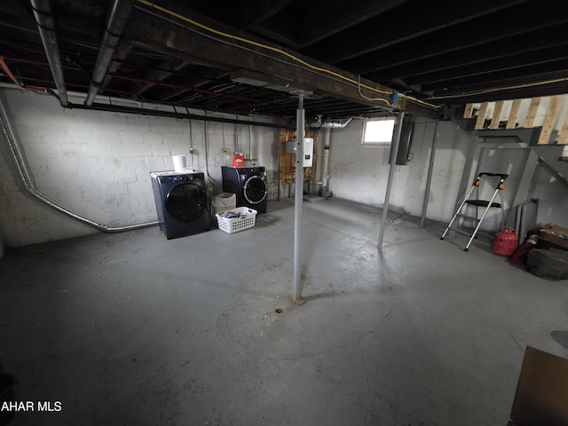 basement featuring electric panel and separate washer and dryer