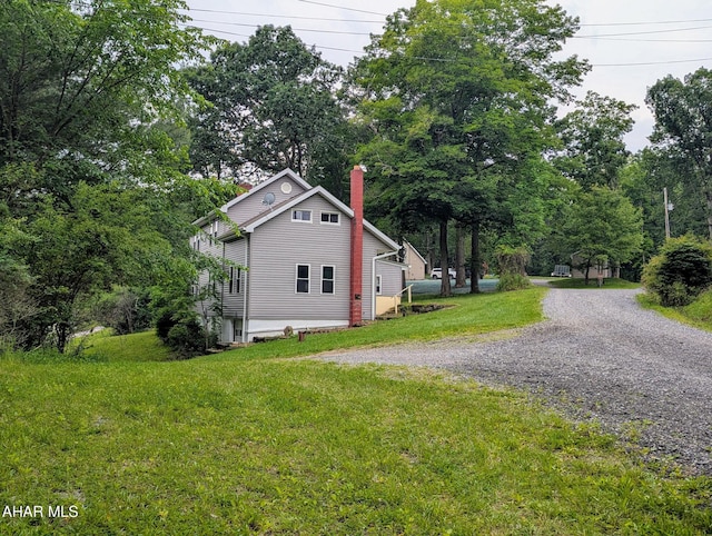 225 Mickel Ln, Duncansville, PA 16635 - view of home's exterior with driveway, a chimney, a lawn, and view of scattered trees