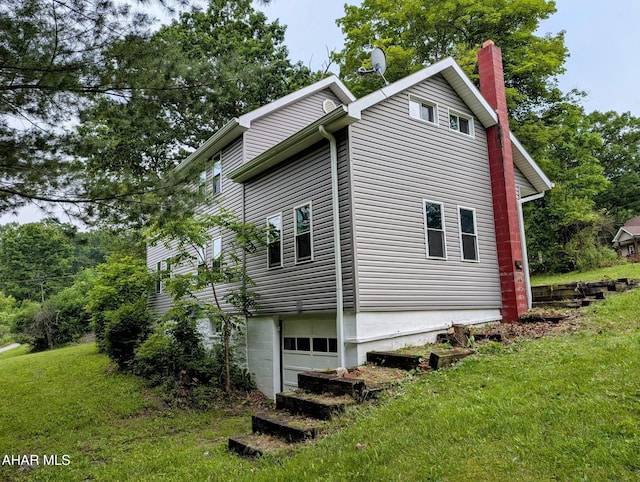 225 Mickel Ln, Duncansville, PA 16635 - view of side of home featuring a chimney, a yard, and an attached garage