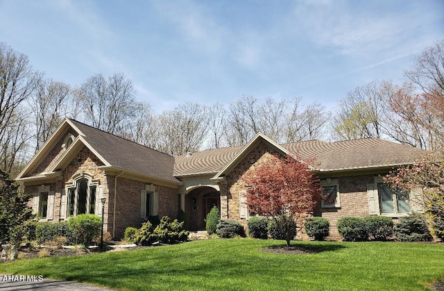 ranch-style home featuring a front yard