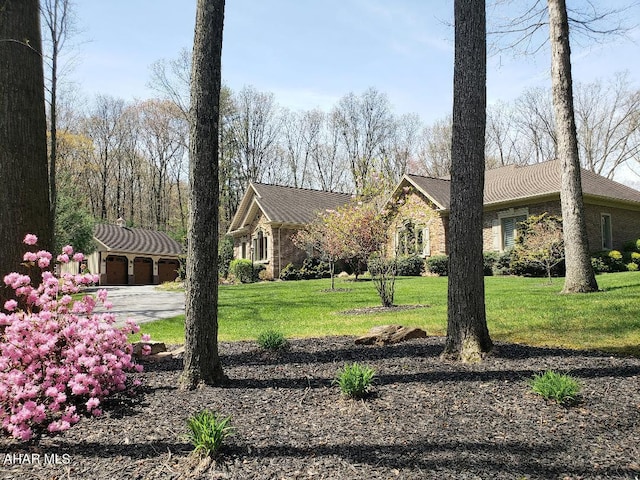 exterior space featuring a front yard, an outdoor structure, and a garage