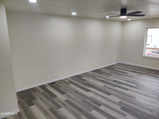 empty room featuring dark hardwood / wood-style floors and ceiling fan