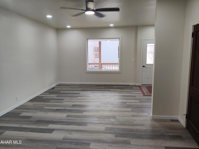 spare room featuring dark hardwood / wood-style floors and ceiling fan