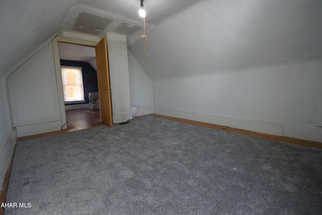 bonus room featuring baseboards, carpet flooring, and vaulted ceiling