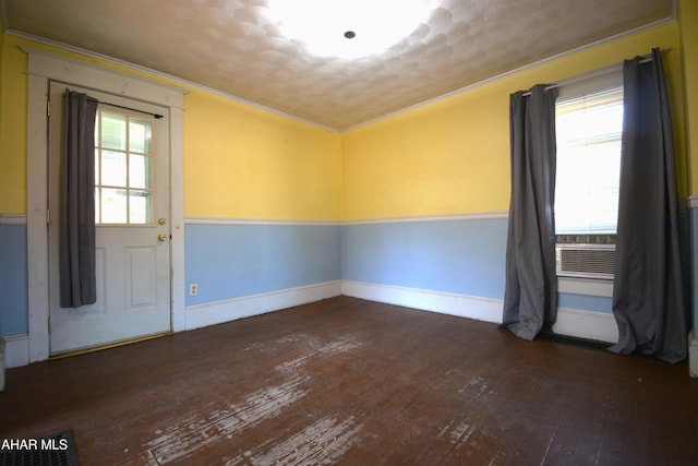 spare room featuring wood-type flooring, ornamental molding, and baseboards