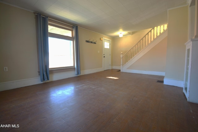 foyer entrance featuring stairs, crown molding, visible vents, and wood finished floors