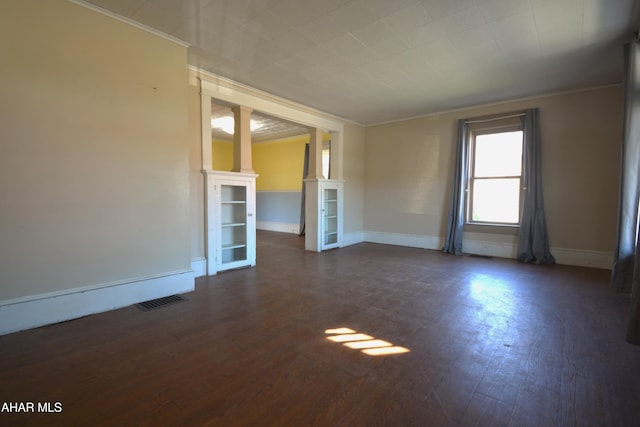 unfurnished room with ornate columns, baseboards, visible vents, and ornamental molding