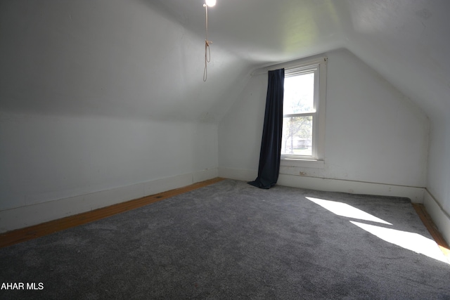 bonus room with carpet and vaulted ceiling