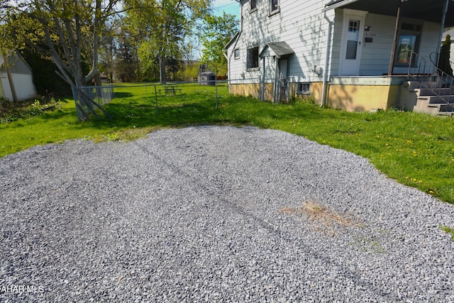 view of yard with a porch and fence