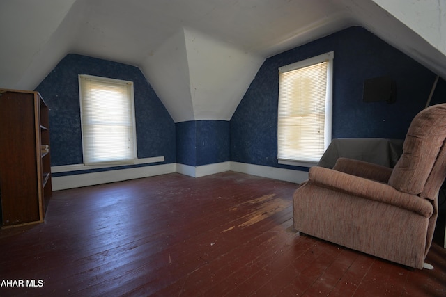 additional living space featuring hardwood / wood-style floors and lofted ceiling