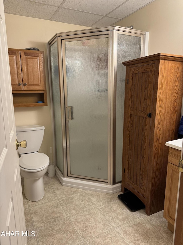 full bathroom with vanity, toilet, tile patterned flooring, and a stall shower