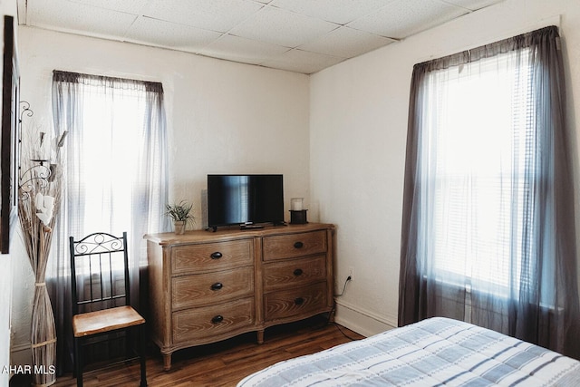 bedroom with dark hardwood / wood-style flooring