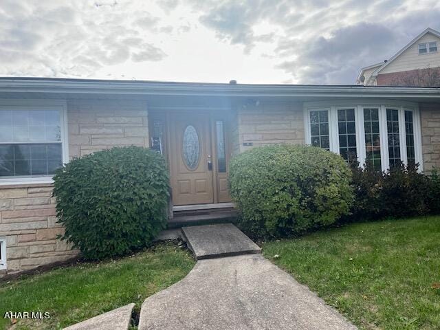 doorway to property with a yard