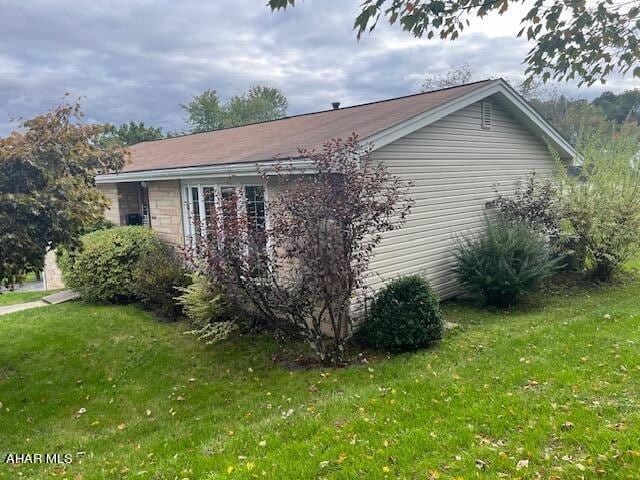 view of property exterior with a yard