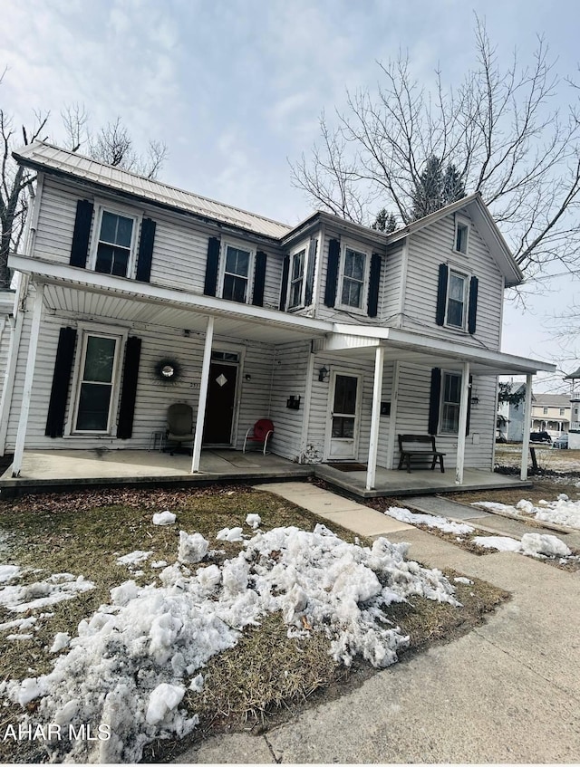 view of front of property featuring covered porch and metal roof