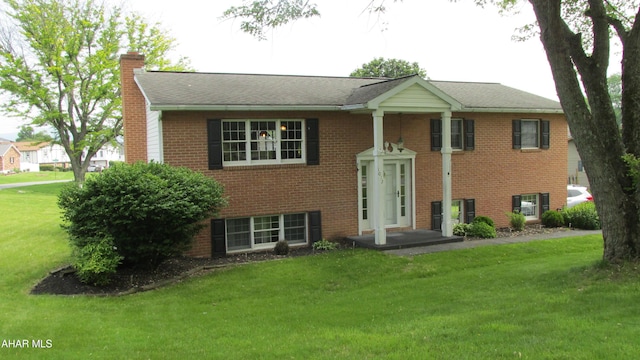 1012 Gray Ln, Duncansville, PA 16635 - bi-level home featuring a chimney, a front lawn, and brick siding