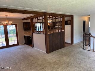 1012 Gray Ln, Duncansville, PA 16635 - bar with a chandelier, carpet flooring, pendant lighting, and fridge