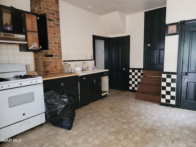 kitchen with sink, white range with gas stovetop, a textured ceiling, and extractor fan