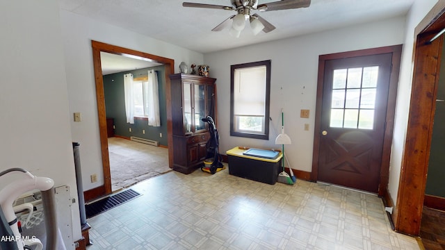 entryway with ceiling fan and a baseboard heating unit