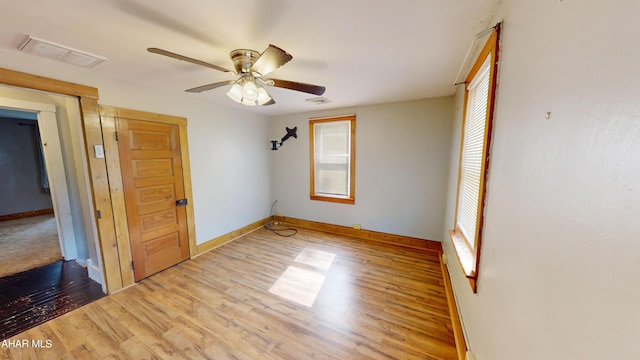 unfurnished bedroom with ceiling fan and light wood-type flooring