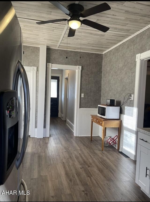 interior space with a healthy amount of sunlight, dark hardwood / wood-style flooring, white cabinetry, and stainless steel refrigerator with ice dispenser