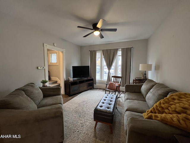 living room featuring wood-type flooring and ceiling fan