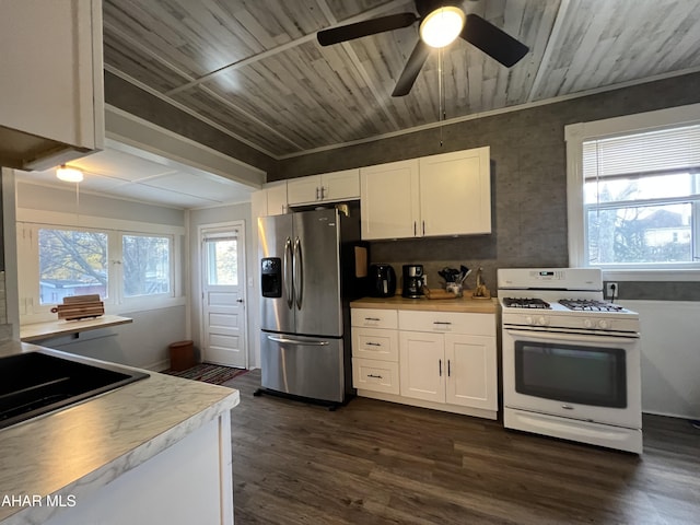 kitchen featuring white cabinetry, white range with gas cooktop, stainless steel fridge with ice dispenser, and a wealth of natural light