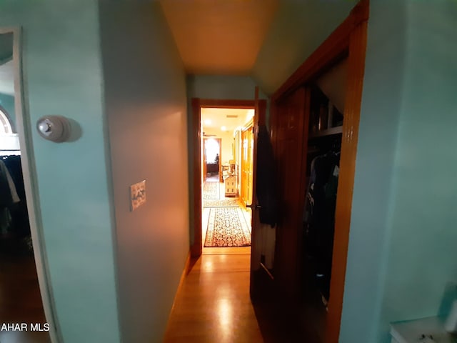 hallway with light hardwood / wood-style flooring